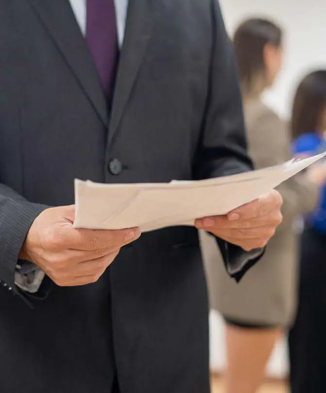 A-man-holding-papers-during-a-business-meeting