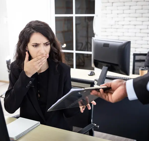 Shocked-female-worker-seeing-a-notice-from-a-manager