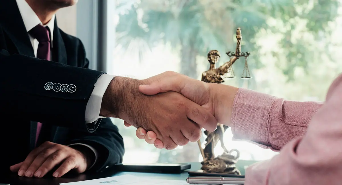 attorney-and-client-shaking-hands-in-office