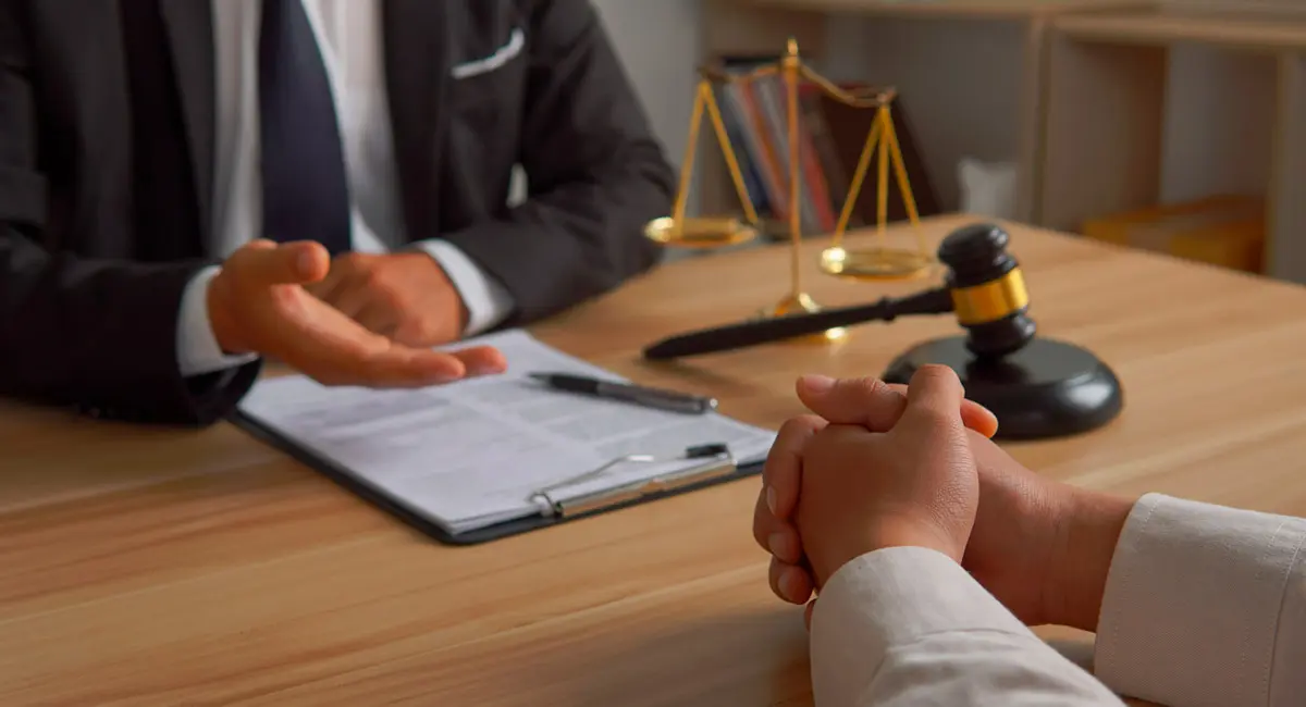 attorney-looking-at-paperwork-with-client-at-table