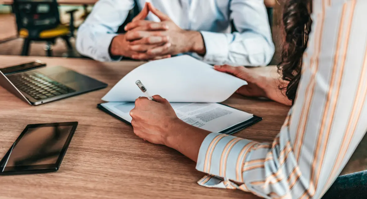 client looking over paperwork with attorney