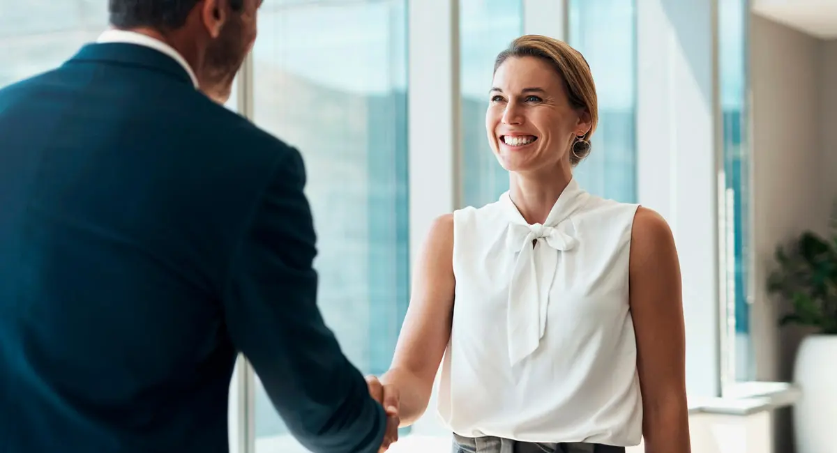 client shaking attorney's hand in office