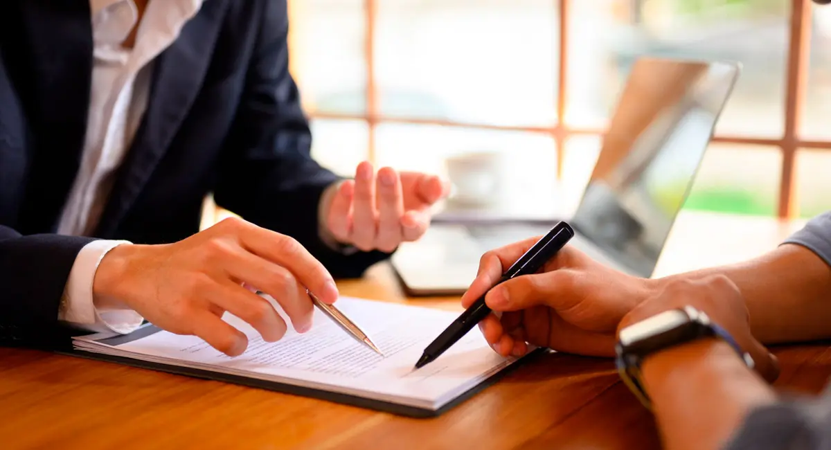 client signing paperwork at lawyer's office