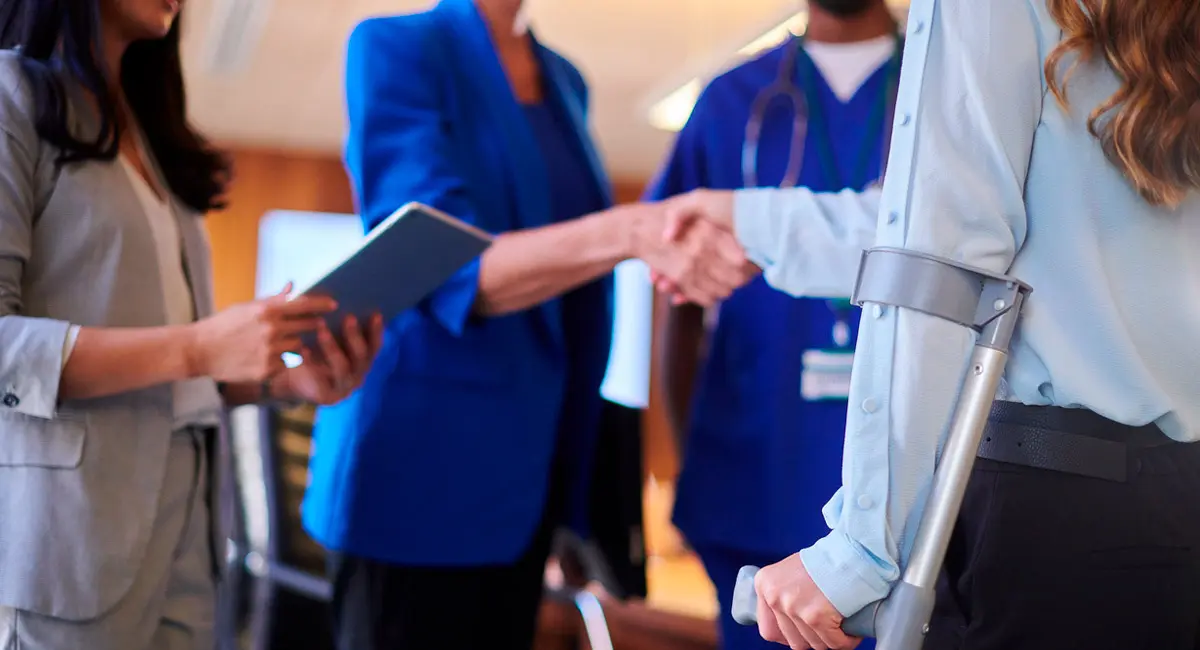 injured-worker-shaking-hands-with-legal-team