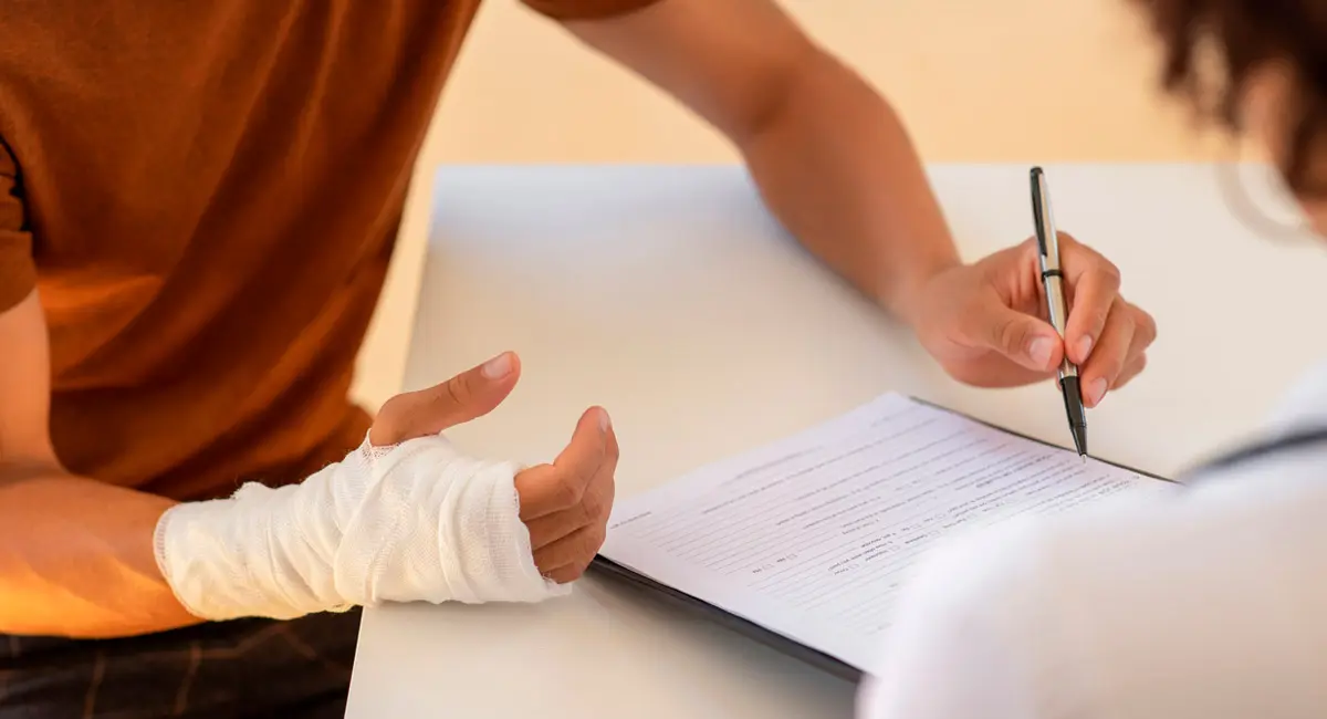 injured-worker-signing-documents-with-attorney