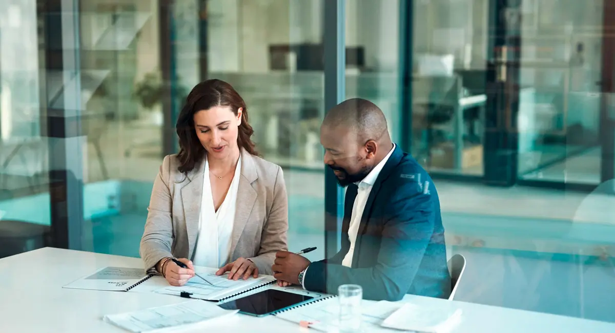 two attorneys looking at case paperwork in conference room