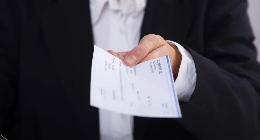 boss-holding-out-payroll-check