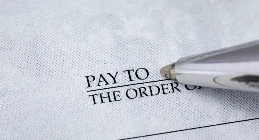 close-up-of-a-check-with-pay-to-the-order-of-visible
