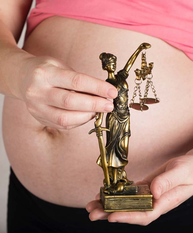 Pregnant-woman-holding-statute-illustrating-justice Pregnant-woman-holding-statute-illustrating-justice