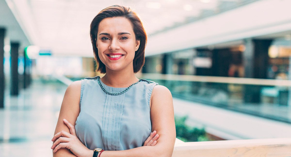 confident-woman-smiling-with-arms-crossed