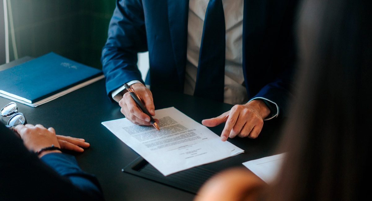 lawyer-looking-over-paperwork-with-clients