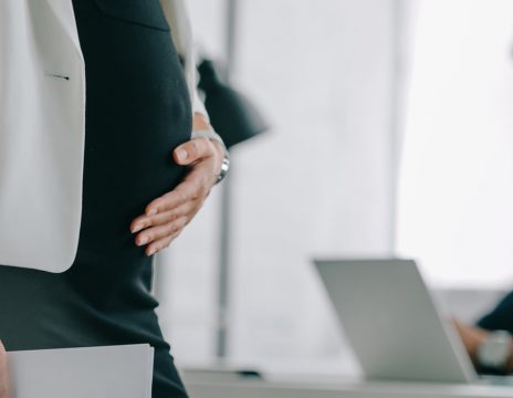 Partial-view-of-pregnant-businesswoman-with-documents