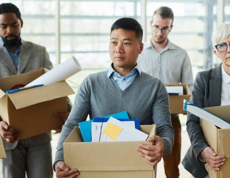 Unhappy-workers-carry-boxes-after-losing-their-jobs
