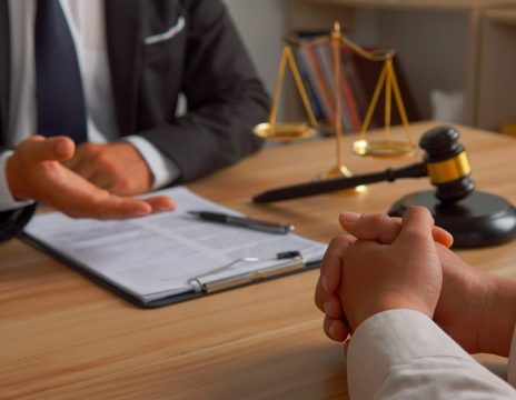 attorney looking at paperwork with client at table