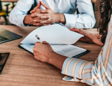 client looking over paperwork with attorney