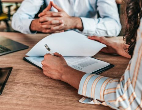 client looking over paperwork with attorney