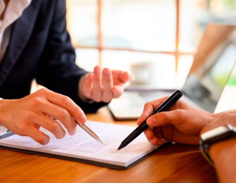 client signing paperwork at lawyer's office
