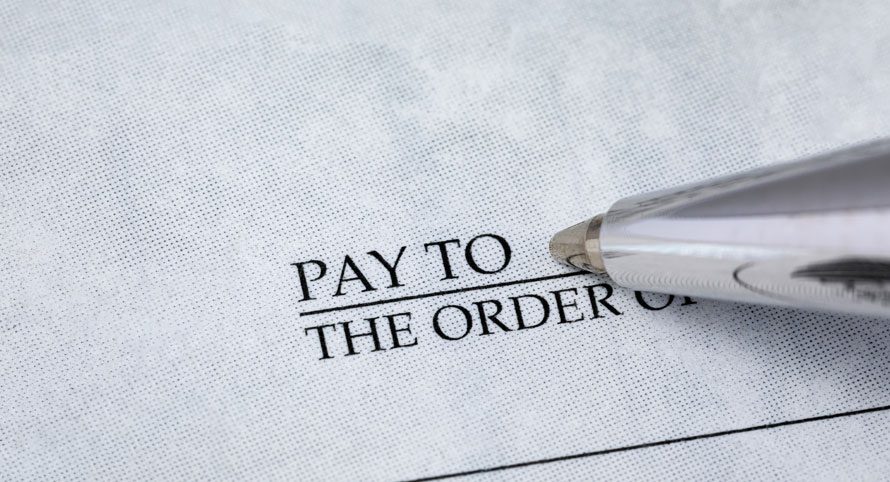 close-up-of-a-check-with-pay-to-the-order-of-visible