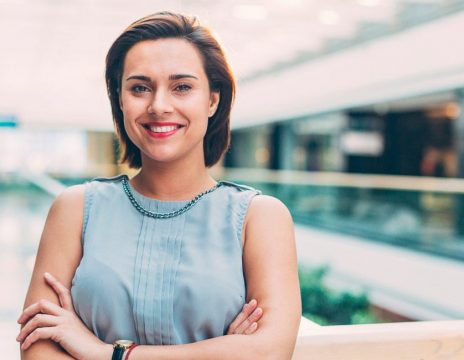 confident woman smiling with arms crossed