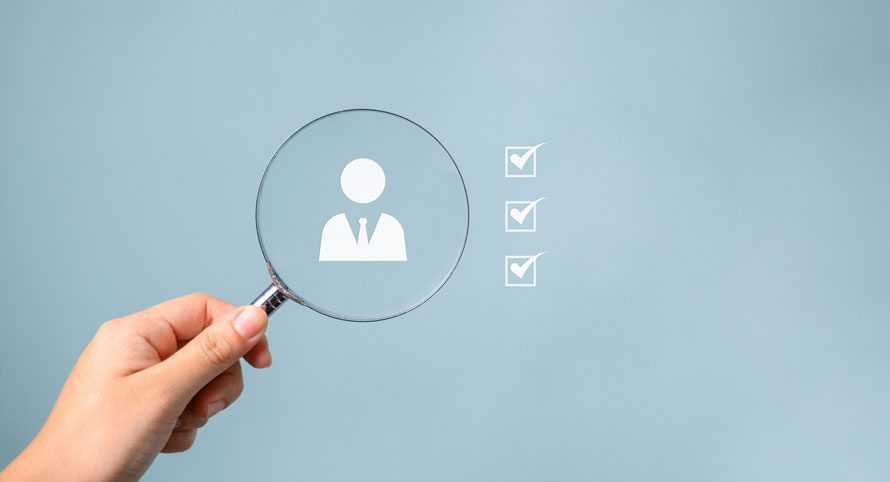 hand-holding-a-magnifying-glass-over-a-person-icon