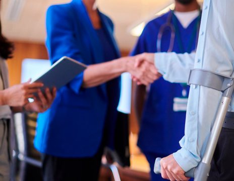 injured worker shaking hands with legal team