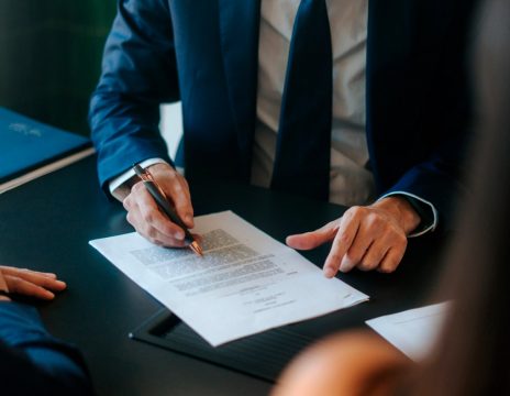 lawyer-looking-over-paperwork-with-clients