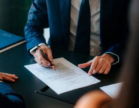 lawyer-looking-over-paperwork-with-clients
