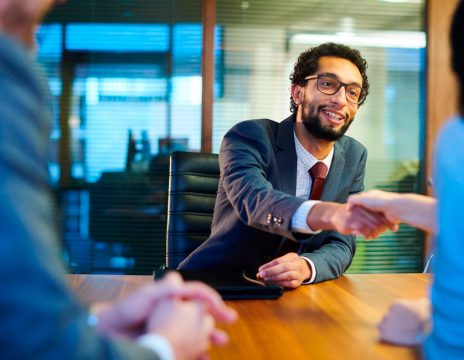 lawyer shaking client's hand at meeting