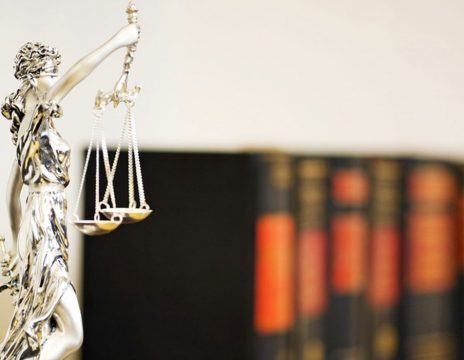 statue-of-lady-justice-in-front-of-a-row-of-law-books