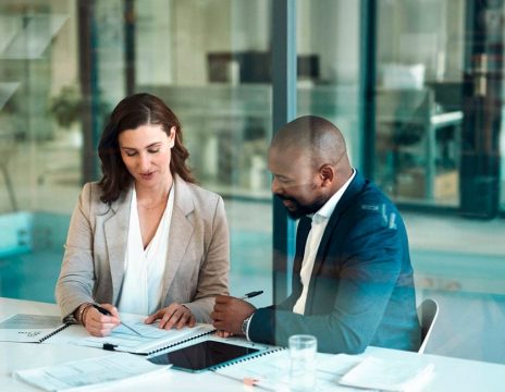 two attorneys looking at case paperwork in conference room