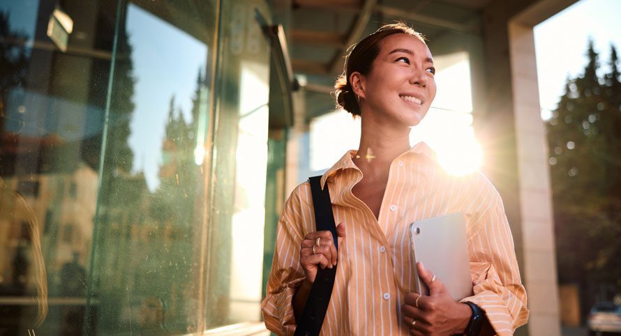 woman-stepping-off-a-bus-in-the-sunlight